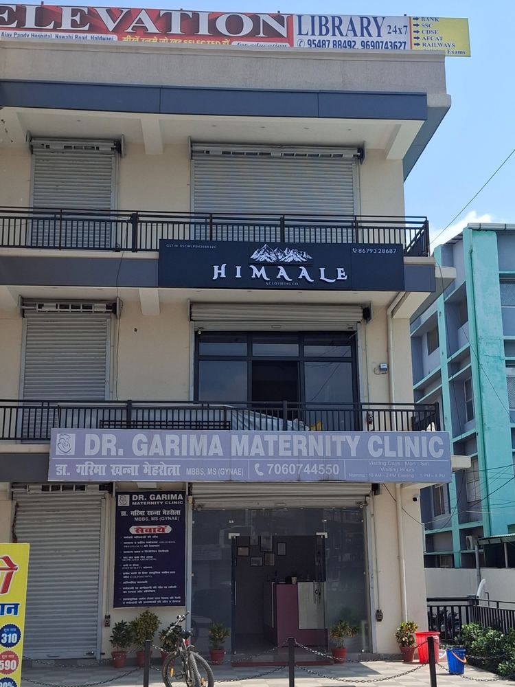 Himaale Clothing Co. & Dr Garima Maternity Clinic storefront signboards