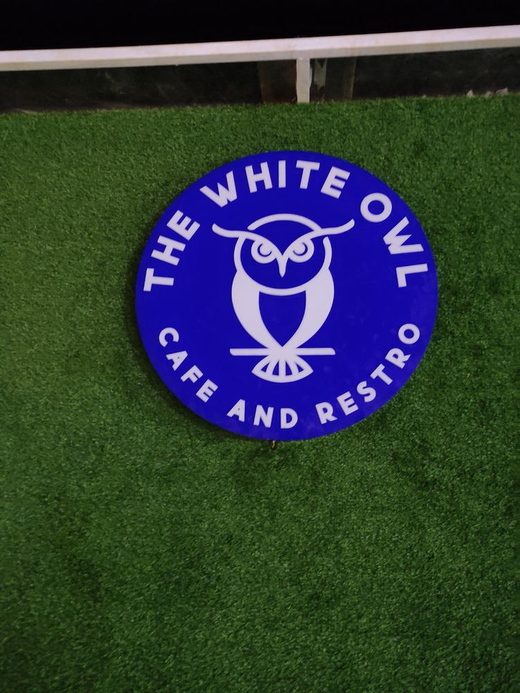 The White Owl Cafe and Restro circular logo signboard